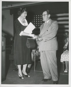 Unidentified woman shaking hands with client at Institute Day