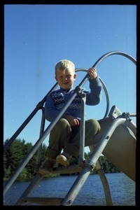 Boy seated atop a slide, Pine Beach