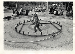 Child playing in dry fountain near Parkman Plaza Learning Sculpture, Boston Common