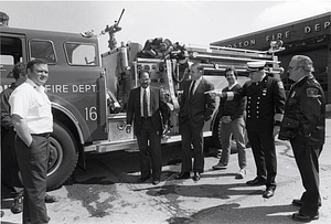 Mayor Raymond L. Flynn and City Councilor Charles Yancey with unidentified fire fighters in front of a fire truick