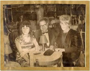 Unknown Party of Three Sit at a Table