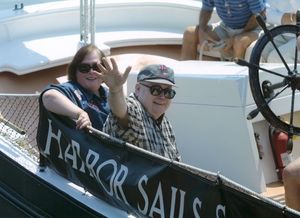Suffolk University Dean Michael Ronayne (CAS) waving from a boat at the 50th reunion for the class of 1951