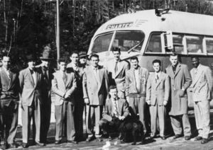 Suffolk University's basketball team and Coach Charlie Law posed in front of bus, 1949