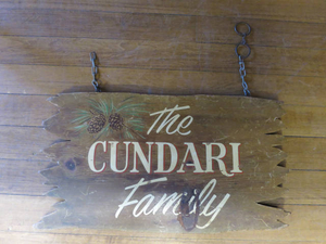 Wooden sign with painted 'The Cundari Family'