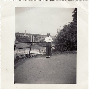 Laymon Hunter poses in front of a bridge over a river