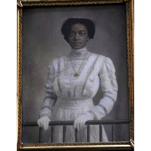 An African American woman clasping a railing