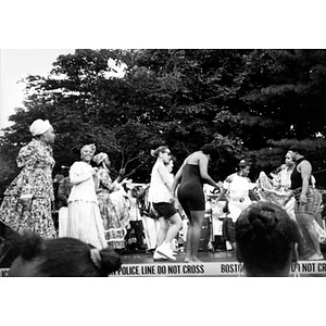 Dancers in folk costume and in street clothes performing on the outdoor stage at Festival Betances.