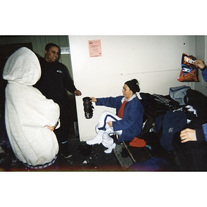 Woman putting on ski boots.