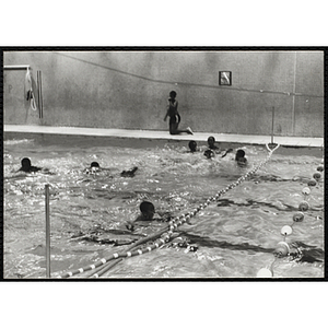 Boys swim in a natorium pool