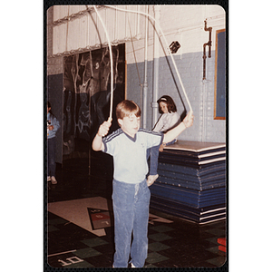 A girl takes off a t-shirt at the Charlestown gymnasium