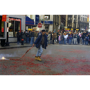 Man performs with firecrackers during a celebration of the Chinese New Year in Boston's Chinatown