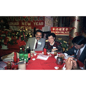 Suzanne Lee sits with guests at a celebration of the Lunar New Year hosted by the Chinese Progressive Association