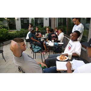 A few male Torch Scholars sit together at the Question and Answer Pizza Party