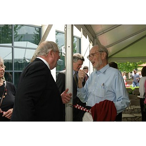 Neal Finnegan speaks with another man at the Veterans Memorial groundbreaking