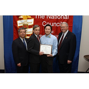 New inductee Victor Tong poses with his certificate and three others at the National Council Dinner