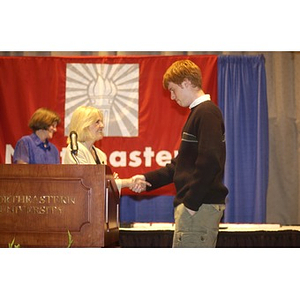 Eric Newell and Karen T. Rigg shaking hands at the Student Activities Banquet