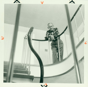 Walter Gropius standing on the upper hallway landing, Gropius House, Lincoln, Mass., undated