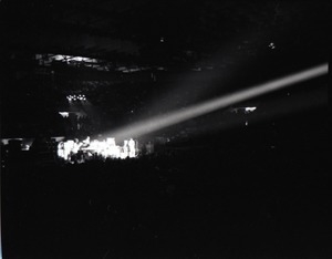 Santana concert at the Springfield Civic Center: distant view of band in performance lit by spotlight