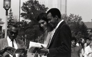 Bill Grabin showing Free Spirit Press magazine to African American faculty members in front of the UMass Amherst Student Union