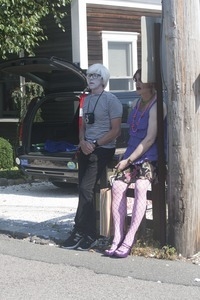 Couple standing next to a telephone pole, one dressed like Andy Warhol : Provincetown Carnival parade