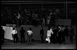 Beatles concert at Shea Stadium: Beatles on stage in performance: Paul McCartney at microphone, George Harrison and John Lennon on guitars, Ringo Starr on drums (l. to r.)