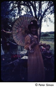 Woman with umbrella and old-fashioned dress, Tree Frog Farm commune
