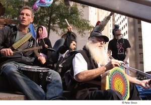 Occupy Wall Street: demonstrator playing drums in a drum circle