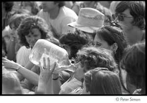 View of an audience member at the No Nukes concert drinking from a gallon jug, Washington, D.C.