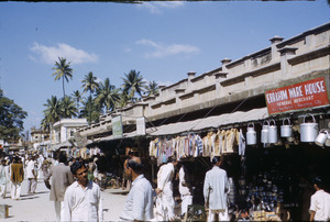 Men walking past shops in the Bangalore bazaar