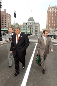 Providence Mayor Vincent Cianci walks across Kennedy Plaza with his limousine trailing and City Hall in the background for the first day of his trial for jury selection on the Plunder Dome investigation of Providence City Hall