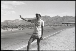 Peace encampment activist flashing peace sign near entrance to the Nevada Test Site