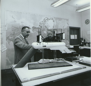 William E. Heronemus standing in front of an ocean current model