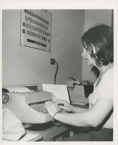 Butila Vera uses a typewriter at TOWER clerical training