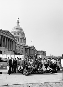 Congressman John W. Olver with large group of visitors, posed in front of the United States Capitol building