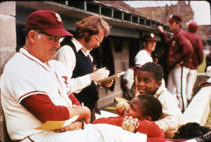 Archie Allen in the dugout with kids