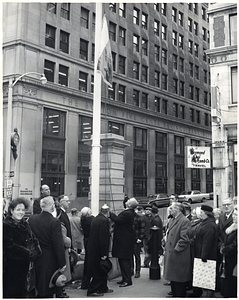 Charles W. Sweeney raises a flag