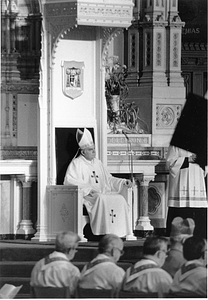 Archbishop Bernard F. Law sitting at altar