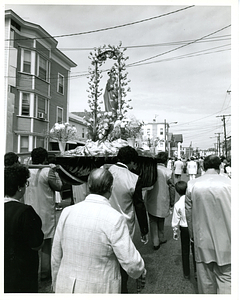 Men carrying statue in procession
