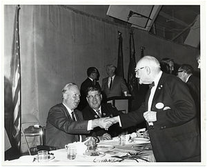 Mayor John F. Collins shakes hands with an unidentified man