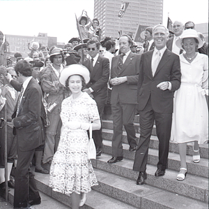 [Queen Elizabeth II, Mayor Kevin White, and Kathryn White walking down the steps of City Hall Plaza]