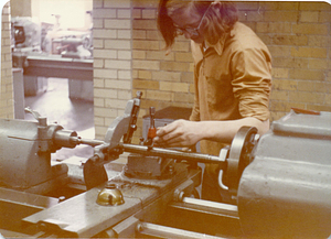 [Student working in machine shop]