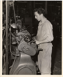 [Student working at a machine]