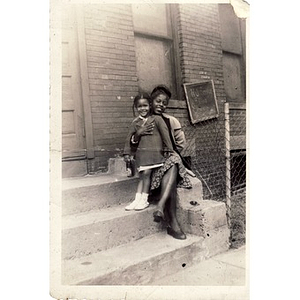 Unidentified woman and child pose in front of church