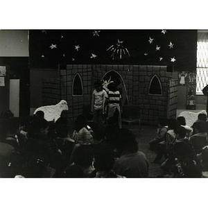 Two children perform in the Three Kings' Day celebration in front of an audience consisting mostly of Hispanic American children and some adults at La Alianza Hispana, Roxbury, Mass
