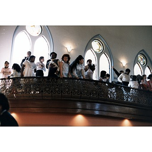 Children gathered on the balcony at the Jorge Hernandez Cultural Center in their dress clothes.