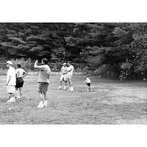 Inquilinos Boricuas en Acción employees standing in a field in a park during a staff outing.