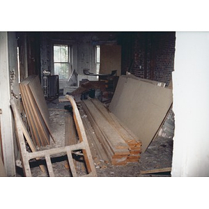 Lumber, plywood, and drywall piled in the interior of 326 Shawmut Avenue.