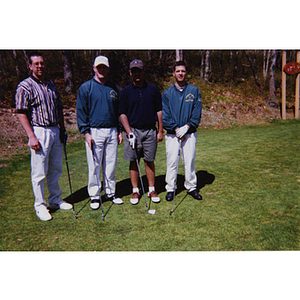 A four-man golf team posing with their clubs at the Charlestown Boys and Girls Club Annual Golf Tournament