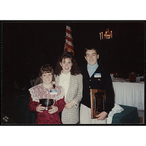 Julie Treanor and Jason Gallagher holding their awards and posing with an unidentified woman at the "Recognition Dinner at Harvard Club"