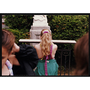 A girl praying in front of a statue during a Boys & Girls Club event